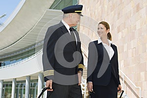 Pilot And Flight Attendant Outside Building