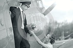 Pilot and girl near vintage aircraft