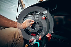 Pilot inside a cockpit small airplane. Pilots hand on the controls