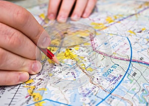 Pilot plotting a course on a map