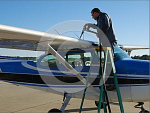 Pilot refueling small airplane