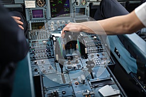 Pilot`s hand accelerating on the throttle in a commercial airlineri
