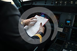 Pilot`s hand  in  a commercial airliner airplane flight cockpit during takeoff