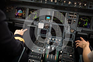 Pilot`s hand  in  a commercial airliner airplane flight cockpit during takeoff