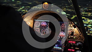 Pilot's hands on steering wheel, night flight, airplane hovering above city