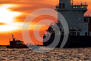 Pilot ship catches big container ship