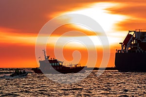 Pilot ship catches big container ship