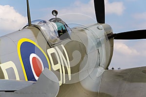 Pilot sits in cockpit of Supermarine Spitfire british fighter aircraft