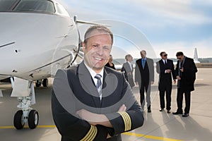 Pilot standing in front of corporate private jet