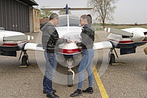 Pilot and Student Discussing Flight Route Over an Aviation Chart