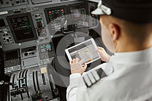 Pilot use digital tablet in passenger airplane jet