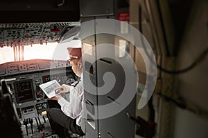 Pilot use digital tablet in passenger airplane jet
