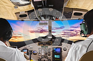 Pilots in the plane cockpit and sunset photo