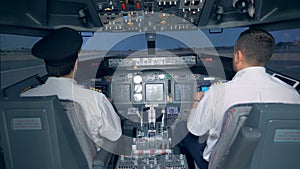 Pilots take the plane off in a flight simulator. 4K.