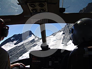Pilots' view during the flight over mountains from the helicopter cabin