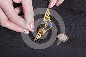 Pilots wings being sewn onto uniform