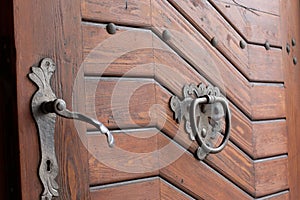 Pilsen, Czech Republic, 1.09.2019 - knoking door handle and lock on ancient door
