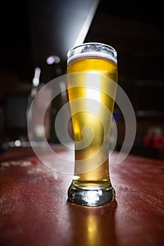 Pilsner beer glass on a table