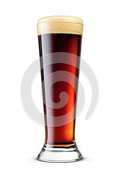 Pilsner glass of fresh dark stout beer with cap of foam isolated on white background