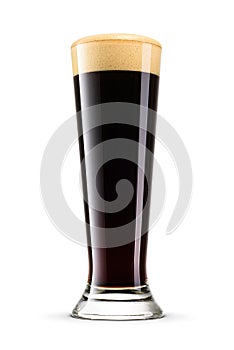 Pilsner glass of fresh dark stout beer with cap of foam isolated on white background