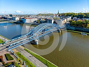 Pilsudski tied arc bridge over Vistula River with tramway in Krakow, Poland