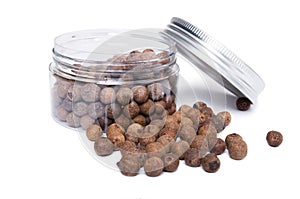 Pimento spice dry seeds in transparent plastic jar