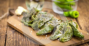 Fresh made Pimientos de Padron on a rustic background photo