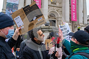 PIMLICO, LONDON - 11 February 2023: People harassing a livestreamer whilst protesting in support of Drag Queen Story Hour at Tate