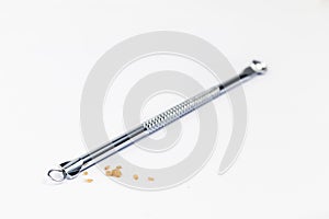 Pimple popping tool and the extracted blackheads photo