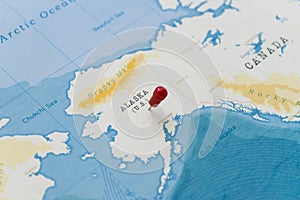 A pin on alaska, United States in the world map