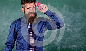Pin it on mind. Teacher bearded man with pink stapler chalkboard background. Teaching memorization techniques. Hipster photo