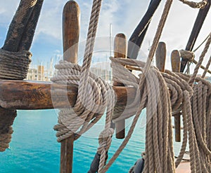 Pin rail with fixed ropes. An old sailing ship