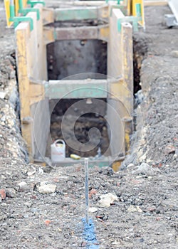 Pin set by site engineer to provide line for digging trench during drainage works on construction site