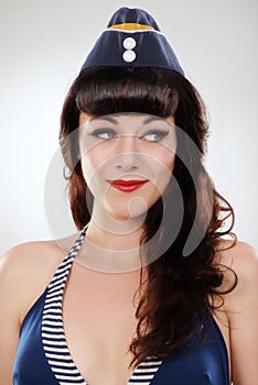 Pin up, fashion and face of a sailor, woman and model in studio isolated on a white background. Retro, travel and