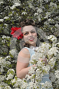 Pin up girl with a dogwood tree in the spring