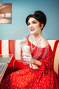pin up girl drinks milkshake through a straw