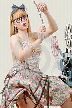 pin-up girl with film reel and vintage projector