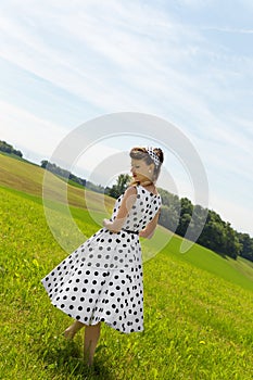 Pin up Girl on a green meadow