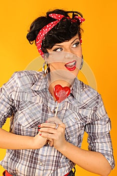Pin up girl with heart shaped lollipop