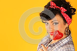 Pin up girl with heart shaped lollipop