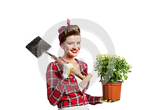 Pin-up girl holding flower pot with yellow daisies and spade