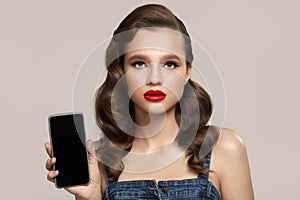 Pin-up girl holds smartphone in hand