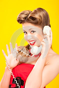 Pin-up girl talking on retro telephone