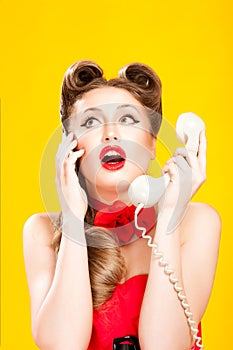 Pin-up girl talking on retro telephone