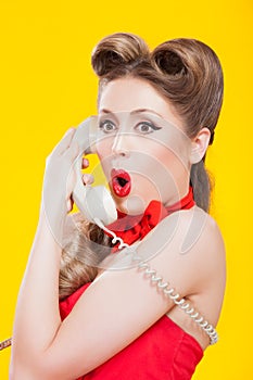 Pin-up girl talking on retro telephone