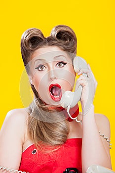 Pin-up girl talking on retro telephone