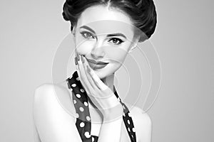 Pin up girl vintage. Beautiful woman pinup style portrait in retro dress and makeup, manicure nails hands, red lipstick and polka