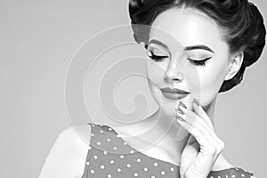 Pin up girl vintage. Beautiful woman pinup style portrait in retro dress and makeup, manicure nails hands, red lipstick and polka