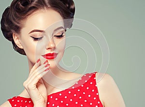 Pin up girl vintage. Beautiful woman pinup style portrait in retro dress and makeup, manicure nails hands, red lipstick and polka