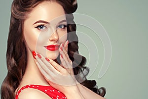 Pin up girl vintage. Beautiful woman pinup style portrait in retro dress and makeup, manicure nails hands, red lipstick and polka